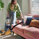 Woman vacuuming with a Vax vacuum cleaner