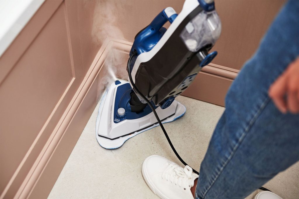 VAX Steam Fresh Home steam cleaner cleaning a corner, reaching into hard-to-reach areas with powerful steam.