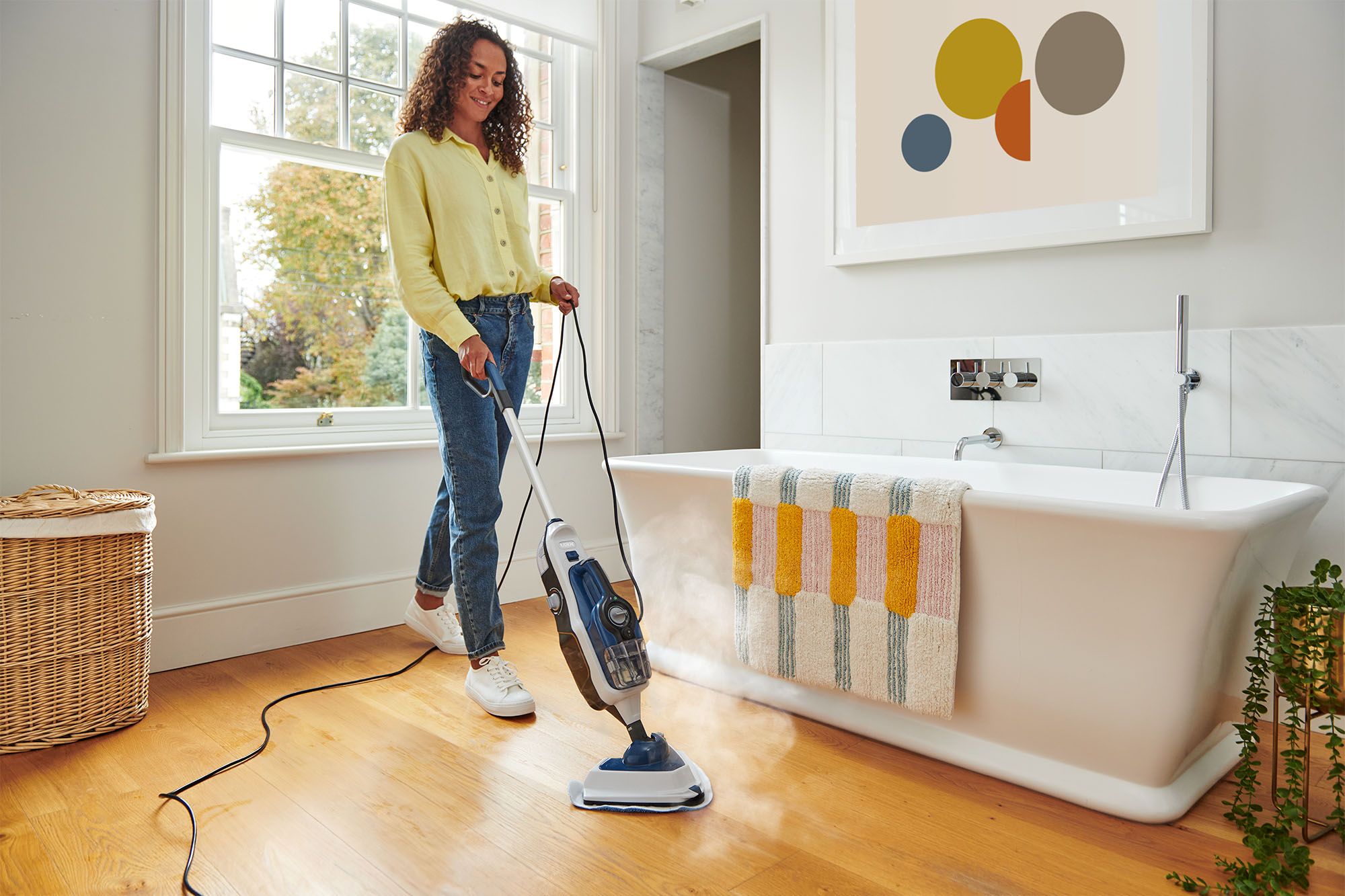 VAX Steam Fresh Home steam cleaner being used to clean a bathroom floor, removing dirt and grime with powerful steam.